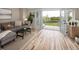 Cozy living room with light wood floors, gray sofa, black coffee table, and French doors leading to a deck with yard views at 4972 Easley Rd, Golden, CO 80403