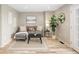 Inviting living room with a comfortable gray sofa, black coffee table, neutral rug, and bright natural light from the windows at 4972 Easley Rd, Golden, CO 80403