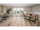 Open living space featuring light wood floors, gray sofa, black coffee table, and a dining area with a round table and four chairs at 4972 Easley Rd, Golden, CO 80403