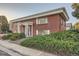 Brick building with a classic design, featuring a blue door and well-maintained landscaping at 450 W Jefferson Ave, Englewood, CO 80110