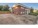 Side view of a brick building showcasing a landscaped yard and parking area at 450 W Jefferson Ave, Englewood, CO 80110