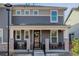 Inviting home exterior with a covered front porch, neutral siding, brick facade and well-kept landscaping at 431 Courtfield Way, Castle Pines, CO 80108