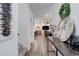 Hallway with views of open concept living and dining area with modern decor and lots of natural light at 431 Courtfield Way, Castle Pines, CO 80108
