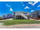 Two-story home with a grassy backyard, patio, and stairs leading to a second-story deck at 4385 Oakes Mill Ct, Castle Rock, CO 80109