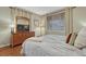 Cozy bedroom featuring a dresser with a TV, a lamp, and a window at 4385 Oakes Mill Ct, Castle Rock, CO 80109