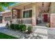 Inviting front porch with decorative columns, cozy seating, and a vibrant red front door at 4385 Oakes Mill Ct, Castle Rock, CO 80109