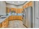 Well-lit kitchen with stainless steel appliances and light wood cabinetry at 4385 Oakes Mill Ct, Castle Rock, CO 80109