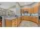 Bright kitchen with granite countertops, wooden cabinets, and tile flooring at 4385 Oakes Mill Ct, Castle Rock, CO 80109