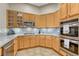 Kitchen showcasing stainless steel appliances, granite countertops, and wood cabinets at 4385 Oakes Mill Ct, Castle Rock, CO 80109