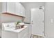 Neat laundry room features a washer, dryer, storage cabinets, and a door to the exterior at 4385 Oakes Mill Ct, Castle Rock, CO 80109