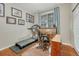 Office features a treadmill, desk, and a large window offering natural light at 4385 Oakes Mill Ct, Castle Rock, CO 80109