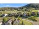 Aerial view of a neighborhood highlighting lush lawns and mountainous backdrop at 24005 High Meadow Dr, Golden, CO 80401