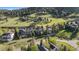 Aerial view of homes nestled among green hills and trees, showcasing a serene and natural landscape at 24005 High Meadow Dr, Golden, CO 80401