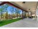 Covered back patio featuring an outdoor dining set and a view of the yard and greenbelt beyond at 24005 High Meadow Dr, Golden, CO 80401
