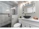 Modern bathroom features a glass-enclosed shower with marble-style tile and black fixtures at 24005 High Meadow Dr, Golden, CO 80401