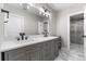 Bathroom featuring marble floors, shower and vanity with double sinks and white countertop at 24005 High Meadow Dr, Golden, CO 80401