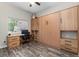 This room features a built-in desk, Murphy bed, storage cabinets and drawers, and neutral decor at 24005 High Meadow Dr, Golden, CO 80401