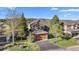 Charming two-story home with mature trees and a basketball hoop in the driveway at 24005 High Meadow Dr, Golden, CO 80401