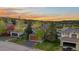 Beautiful home with a warm exterior, complemented by lush greenery and picturesque mountain views at sunset at 24005 High Meadow Dr, Golden, CO 80401