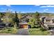 Inviting home with a well-manicured lawn, mature trees, and a spacious driveway for easy parking at 24005 High Meadow Dr, Golden, CO 80401