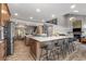 Open kitchen with island, seating, wood floors, and modern stainless appliances at 24005 High Meadow Dr, Golden, CO 80401
