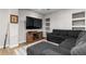 Cozy living room with a large sectional sofa, TV, shelving, and rustic wood accents at 24005 High Meadow Dr, Golden, CO 80401