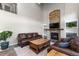 Cozy living room with stone fireplace, large windows, and comfortable leather furniture at 24005 High Meadow Dr, Golden, CO 80401