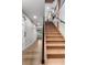 Bright staircase with wood treads, black metal railing, and landing with view to the backyard at 24005 High Meadow Dr, Golden, CO 80401