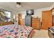 Comfortable bedroom featuring a patterned quilt on the bed and a large window at 12317 Fillmore Ct, Thornton, CO 80241