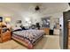 This bright bedroom features a patterned quilt on the bed and a large window at 12317 Fillmore Ct, Thornton, CO 80241