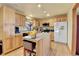 Spacious kitchen featuring granite counters, center island, and wood cabinetry at 12317 Fillmore Ct, Thornton, CO 80241