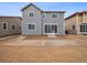 Exterior view of gray two-story home with sliding glass doors leading to a partially landscaped backyard at 24777 E 40Th Ave, Aurora, CO 80019