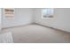 A bright and spacious bedroom with neutral carpet, white walls, and natural light through windows, ready for personalization at 24777 E 40Th Ave, Aurora, CO 80019