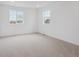A bright bedroom with carpet, white walls, with two windows offering natural light and a neighborhood view at 24777 E 40Th Ave, Aurora, CO 80019