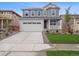 Charming two-story home with a well-manicured lawn and a spacious driveway leading to the garage at 24777 E 40Th Ave, Aurora, CO 80019