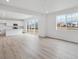 Bright living room with natural light, sliding glass doors to the outside, recessed lights and wood-style flooring at 24777 E 40Th Ave, Aurora, CO 80019