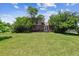 Backyard surrounded by lush foliage, with a well-maintained lawn and privacy fence for a serene outdoor setting at 1808 Riverview Dr, Berthoud, CO 80513