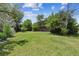 Lush backyard with green lawn and trees creating a private outdoor oasis at 1808 Riverview Dr, Berthoud, CO 80513