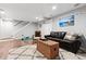 Finished basement with comfortable seating, decorative rug, and access to the staircase at 1808 Riverview Dr, Berthoud, CO 80513