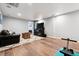 Spacious finished basement featuring hardwood flooring, workout equipment and comfortable furnishings at 1808 Riverview Dr, Berthoud, CO 80513