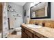 Charming bathroom with vanity, framed mirror, decorative shelves and fixtures at 1808 Riverview Dr, Berthoud, CO 80513