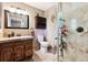 Bathroom featuring glass enclosed shower, tiled walls, vanity with storage and great lighting at 1808 Riverview Dr, Berthoud, CO 80513