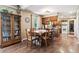 Comfortable dining room with beautiful hardwood floors that adjoins an open kitchen and an adjacent living area at 1808 Riverview Dr, Berthoud, CO 80513