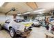 Spacious garage with multiple project cars, equipped for automotive enthusiasts and hobbyists at 1808 Riverview Dr, Berthoud, CO 80513