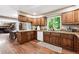 Spacious kitchen featuring oak cabinets, modern appliances, and an open layout that connects to the dining area at 1808 Riverview Dr, Berthoud, CO 80513