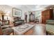 Elegant living room with hardwood floors, coffered ceilings, and vintage furniture for relaxing and entertaining at 1808 Riverview Dr, Berthoud, CO 80513