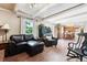 Open concept living room showcases the wood floors and beamed ceilings, leading to kitchen at 1808 Riverview Dr, Berthoud, CO 80513