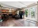 Inviting living room with a brick fireplace, beamed ceilings and access to the outdoors at 1808 Riverview Dr, Berthoud, CO 80513