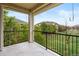 Private balcony overlooking a lush green lawn and neighboring townhomes, offering a serene outdoor space at 11364 Xavier Dr # 205, Westminster, CO 80031
