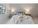 Serene bedroom with a plush bed, stylish nightstands, and a view to the outside at 11364 Xavier Dr # 205, Westminster, CO 80031